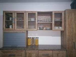 a kitchen with wooden cabinets and a counter top at Drakensview guesthouse in Acornhoek