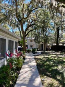 a house with a sidewalk in front of a yard at Beautiful farmhouse in Fernandina Beach in Fernandina Beach