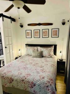 a bedroom with a bed with a ceiling fan at Beautiful farmhouse in Fernandina Beach in Fernandina Beach