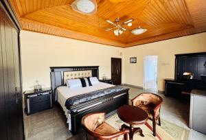 a bedroom with a bed with a wooden ceiling at Silent night in Kumasi