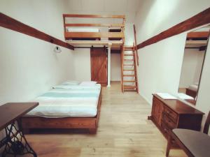 a bedroom with a bed and stairs in a room at Agroturystyka "Dobre czasy" in Sławno