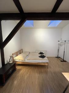 sypialnia z łóżkiem w pokoju z drewnianą podłogą w obiekcie Schönes Appartment in Zentrumsnähe w Grazu