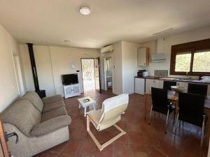 a living room with a couch and a table and a kitchen at Villa Arriba in Periana