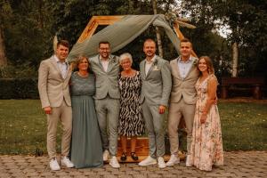 a group of people posing for a picture at a wedding at Restaurant - Pension Im Pfenn in Irrhausen