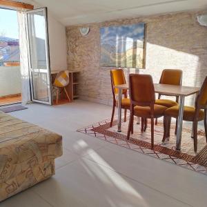 a dining room with a table and chairs in a room at Apartments "Belle Vue" in Herceg-Novi