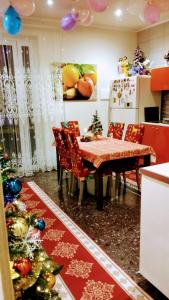 a dining room with a christmas tree and a table at La Casa di Sonia in Savona