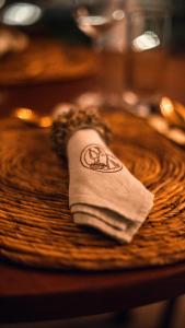 a napkin sitting on top of a wooden table at Anacardier Privé Hotel in Atins