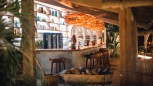 un bar con un montón de taburetes en un restaurante en Anacardier Privé Hotel en Atins