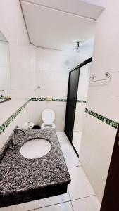 a bathroom with a sink and a toilet at GB Hotéis Foz in Foz do Iguaçu +49 photos