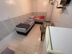 a room with two beds and a table in it at Hospedaria Cmc unidade 12 in Brasilia