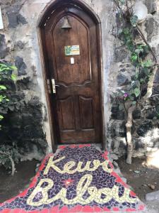 a wooden door with a welcome mat in front of it at Fabuleux Studio Petit Marrakech in Dakar