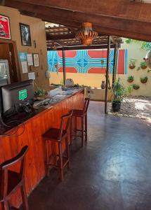 a bar with chairs and a computer on top of it at Savana Hostel in Sao Jorge