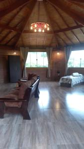 a large living room with a couch and a bed at Pousada Sons do Silêncio in Socorro