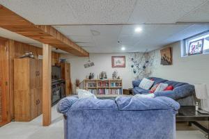 a living room with two blue couches at Welcoming Duluth Home about 2 Mi to Brighton Beach! in Duluth