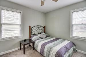 a bedroom with a bed and two windows at Welcoming Duluth Home about 2 Mi to Brighton Beach! in Duluth
