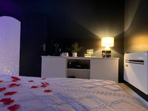a bedroom with a bed with red roses on it at Loving room cocooning l’Air in Jujurieux