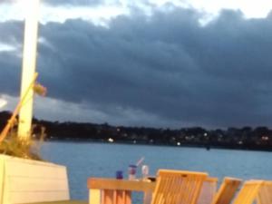 a group of chairs sitting next to a body of water at Cottage chaleureux in Locquirec