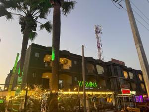 um edifício com palmeiras em frente em Apartments Plaza Hotel em Kololi