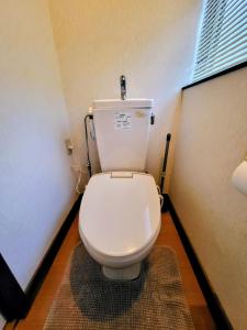 a bathroom with a white toilet in a room at Powder Peak Misorano Free courtesy car in Hakuba