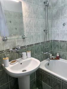 a bathroom with a sink and a bath tub at Pirostka Vintage Room in Sofia +11 photos