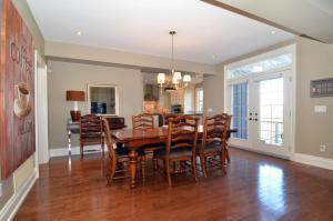 a dining room with a wooden table and chairs at Beautiful ski chalet in the blue mountains w/private hottub spa, fireplace! in Collingwood