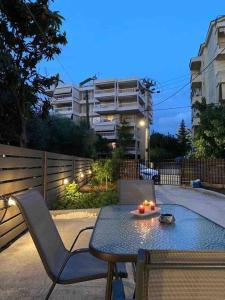 a table and chairs with a candle on it at D & A house 150m from Chalandri metro station in Athens +25 photos
