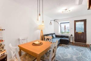 a living room with a table and a couch at Quiet & Secluded St Albans House in Saint Albans