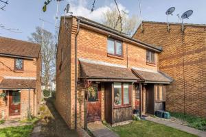 an old brick house with a garage at Quiet & Secluded St Albans House in St. Albans