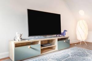 a flat screen tv on a entertainment center in a living room at Quiet & Secluded St Albans House in Saint Albans