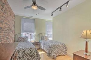 a bedroom with two beds and a ceiling fan at Chase Apartments Light St Convention Center FREE PARKING in Baltimore