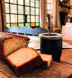 a table with a loaf of bread and a cup of coffee at Las Pircas, casa de campo in Ciudad Lujan de Cuyo