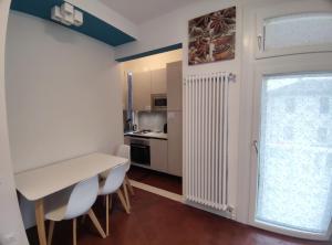 a kitchen with a table and chairs and a window at BBConegliano Bixio in Conegliano