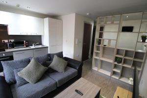 een woonkamer met een bank en een keuken bij Lovely Studio Flat in Bolton in Bolton