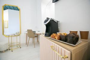 a counter with a tray of pastries on it at Caffe' e Cuscino in Rome