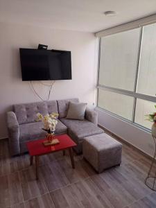 sala de estar con sofá y mesa en Apartamento 2 habitaciones, en Barranquilla