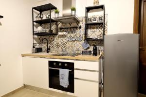 a kitchen with a refrigerator and a counter top at la casa di carta al duomo in Catania