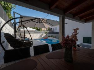 a patio with a table and chairs and an umbrella at Adam apartments in Stobreč