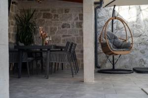 a dining room with a table and a chair at Adam apartments in Stobreč