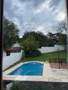 a swimming pool in the backyard of a house at Apartamento Remansum in Santa Rosa de Calamuchita