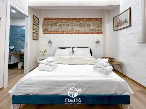 ein Schlafzimmer mit einem großen Bett mit Handtüchern darauf in der Unterkunft MareMò Accomodations - Rooms in Tropea in Tropea