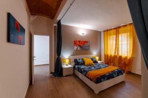 a bedroom with a bed and a window with yellow curtains at Casa R&R 5' a PIEDI dalla Torre! in Pisa +19 photos