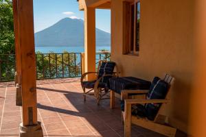 a porch with chairs and a view of a mountain at Casa Maria Vista, Espectacular View in Santa Cruz La Laguna