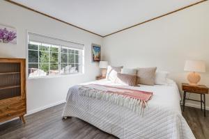 a white bedroom with a bed and a window at Charming Petaluma Cottage with Grill Near Wineries in Petaluma