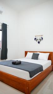 Postel nebo postele na pokoji v ubytování Wangi Homestay