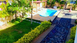 an image of a swimming pool in a yard at 3 bedrooms villa with shared pool furnished terrace and wifi at Pointe aux Piments in Pointe aux Piments