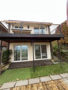 a house with a balcony on top of it at Otter Holt, beautiful East Devon in Tipton Saint John