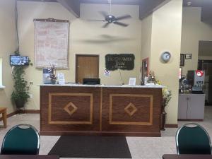 a reception desk in a waiting room with chairs at Rodeway Inn in Zanesville