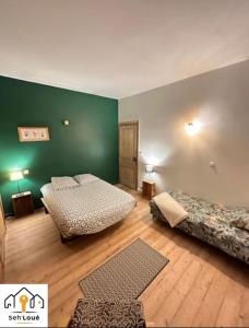 Кровать или кровати в номере Ulyssee Seh’Loué