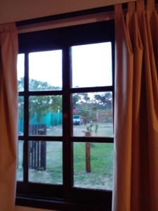 a window with a view of a yard at La Gitana - Casa en La Paloma in La Paloma