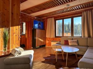 a living room with a couch and a table at Chalet Pohoda in Donovaly